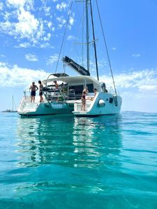 Sailing Athens Catamaran boat tours and cruises in Saronic Gulf, Athenian Riviera in Greece. Family swimming in Athens. Summer vacation.